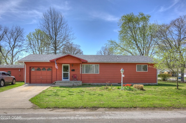 ranch-style home featuring a shingled roof, a garage, a front yard, and concrete driveway