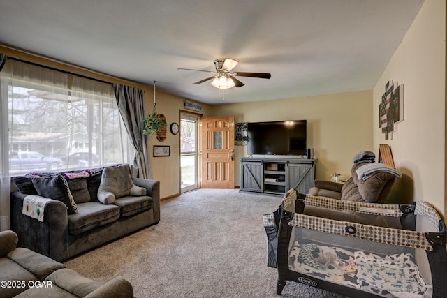 living room with a ceiling fan and carpet flooring