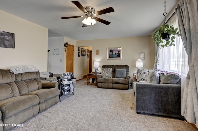 living room featuring ceiling fan and carpet