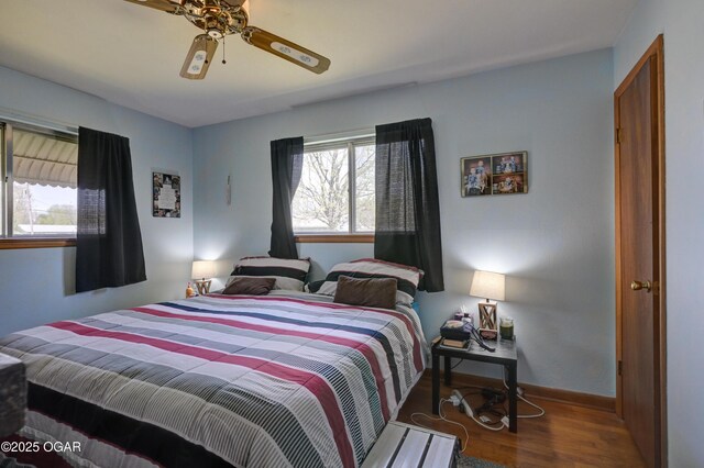 bedroom with baseboards, ceiling fan, and wood finished floors