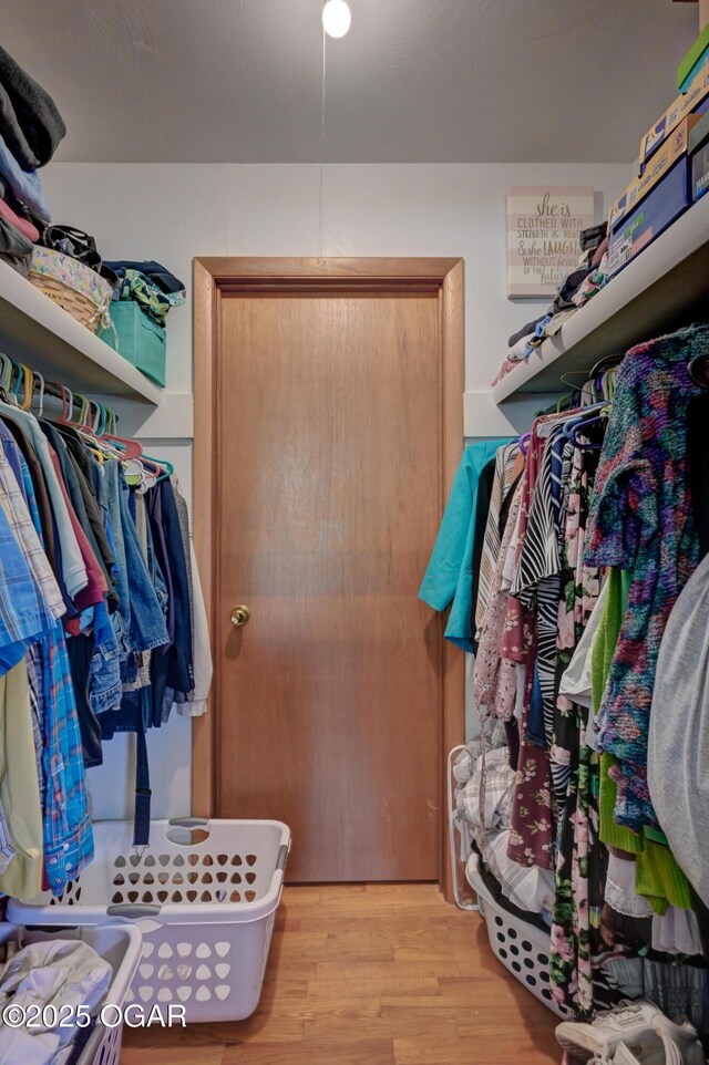 spacious closet with wood finished floors