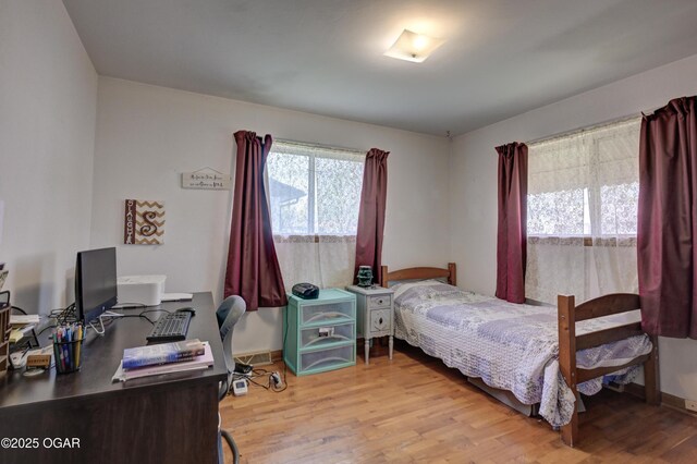 bedroom with wood finished floors and baseboards