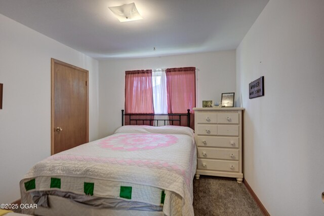bedroom with baseboards and carpet