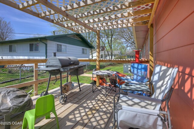 deck featuring a grill and a pergola