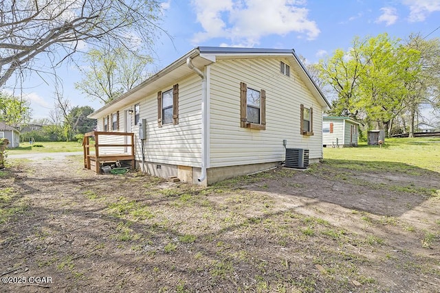 view of home's exterior with a yard, central AC unit, and crawl space