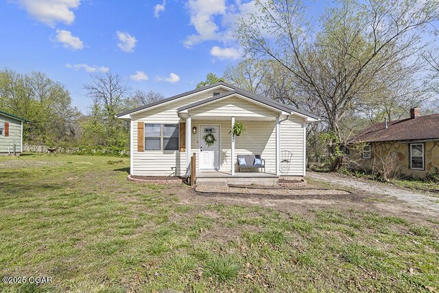 view of front of property with a front yard and a porch