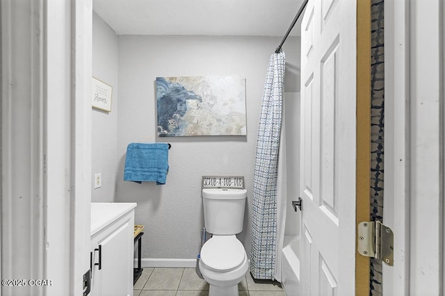 bathroom featuring baseboards, a shower with curtain, toilet, vanity, and tile patterned flooring