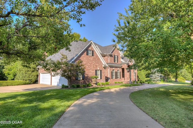1000 Oakmont Dr, Joplin, MO 64804 - view of front of property featuring brick siding, a front yard, an attached garage, and driveway