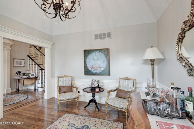 1000 Oakmont Dr, Joplin, MO 64804 - living area with a chandelier, wood finished floors, visible vents, and stairway