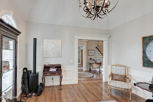 1000 Oakmont Dr, Joplin, MO 64804 - living area featuring a notable chandelier, wood finished floors, stairs, a wainscoted wall, and lofted ceiling