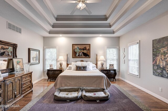 1000 Oakmont Dr, Joplin, MO 64804 - bedroom featuring visible vents, a tray ceiling, baseboards, and wood finished floors