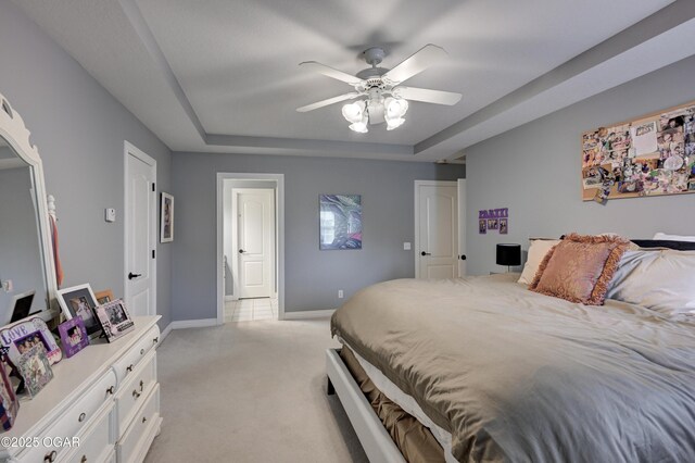 1000 Oakmont Dr, Joplin, MO 64804 - bedroom with baseboards, a raised ceiling, ceiling fan, and light colored carpet