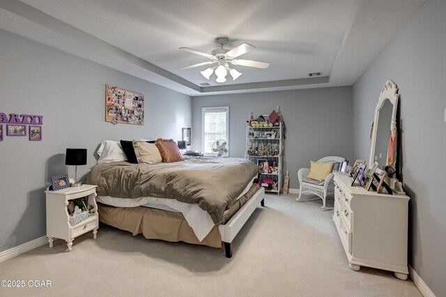 1000 Oakmont Dr, Joplin, MO 64804 - bedroom featuring ceiling fan, a tray ceiling, light colored carpet, visible vents, and baseboards