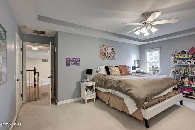 1000 Oakmont Dr, Joplin, MO 64804 - bedroom featuring visible vents, baseboards, a tray ceiling, and light colored carpet