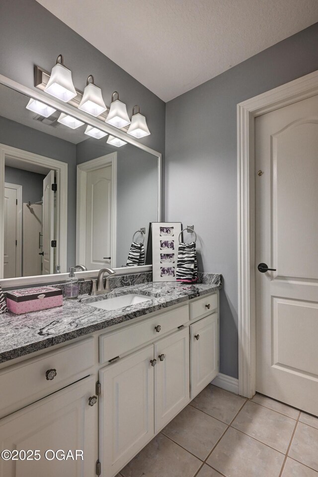 1000 Oakmont Dr, Joplin, MO 64804 - bathroom featuring tile patterned floors, vanity, and baseboards