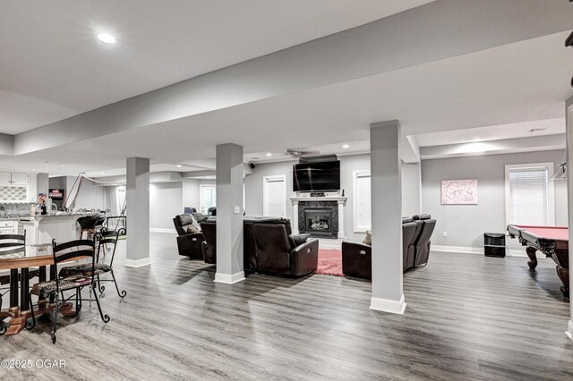 1000 Oakmont Dr, Joplin, MO 64804 - interior space with recessed lighting, a fireplace with raised hearth, baseboards, and wood finished floors