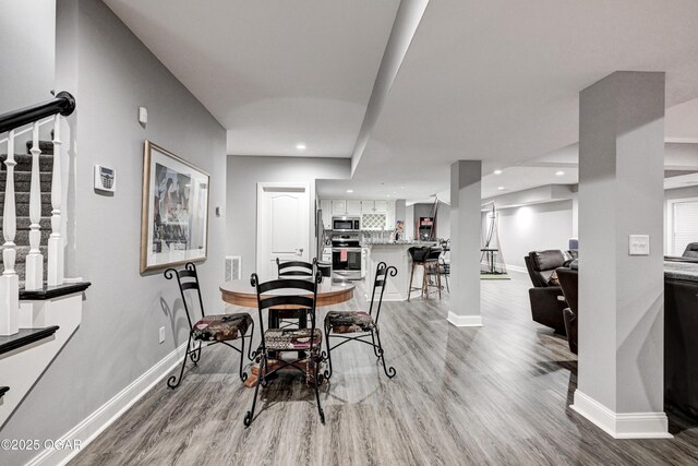 1000 Oakmont Dr, Joplin, MO 64804 - dining space featuring stairs, light wood-style flooring, and baseboards