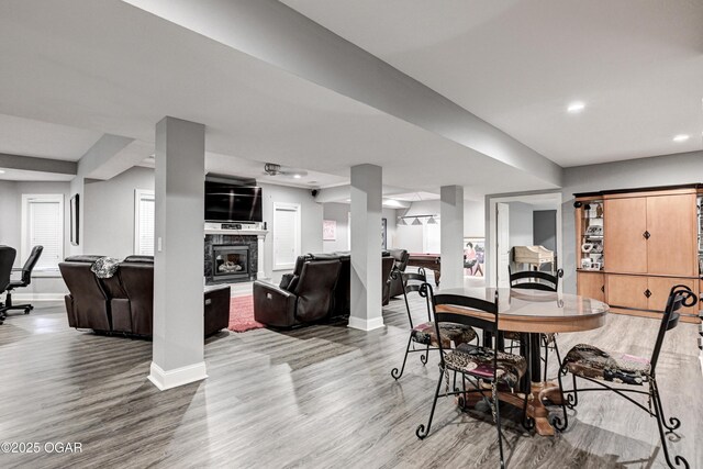1000 Oakmont Dr, Joplin, MO 64804 - dining area with light wood finished floors, baseboards, a glass covered fireplace, and recessed lighting
