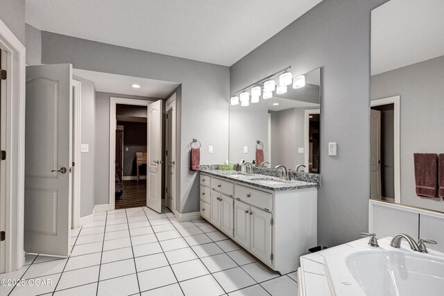 1000 Oakmont Dr, Joplin, MO 64804 - full bathroom with tile patterned floors, double vanity, a bath, and a sink