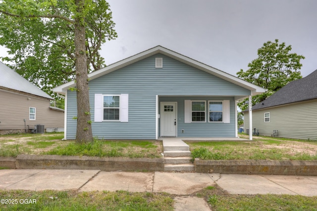 1212 E Broadway St, Joplin, MO 64801 - bungalow with a porch and cooling unit