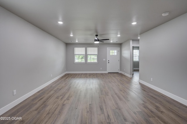 1212 E Broadway St, Joplin, MO 64801 - unfurnished living room featuring ceiling fan, recessed lighting, wood finished floors, and baseboards