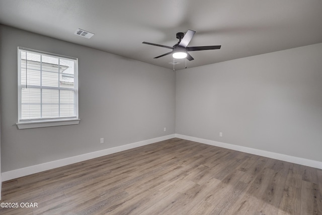 1212 E Broadway St, Joplin, MO 64801 - empty room with ceiling fan, wood finished floors, and baseboards