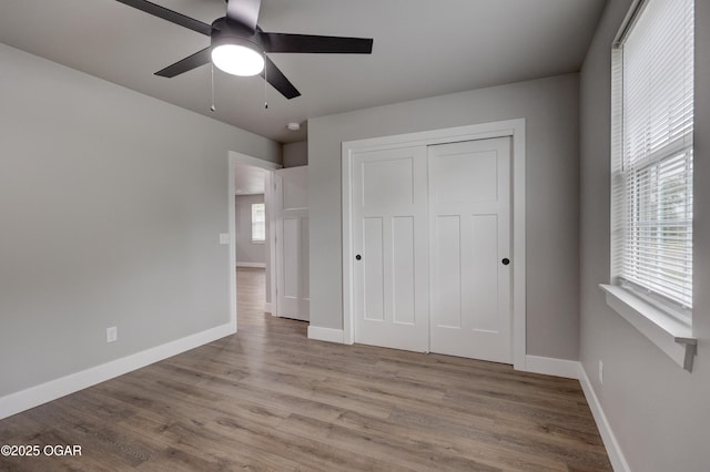 1212 E Broadway St, Joplin, MO 64801 - unfurnished bedroom featuring wood finished floors, baseboards, a closet, and ceiling fan