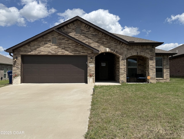 french country style house with roof with shingles, a front lawn, brick siding, a garage, and concrete driveway