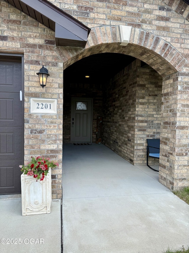 property entrance with brick siding