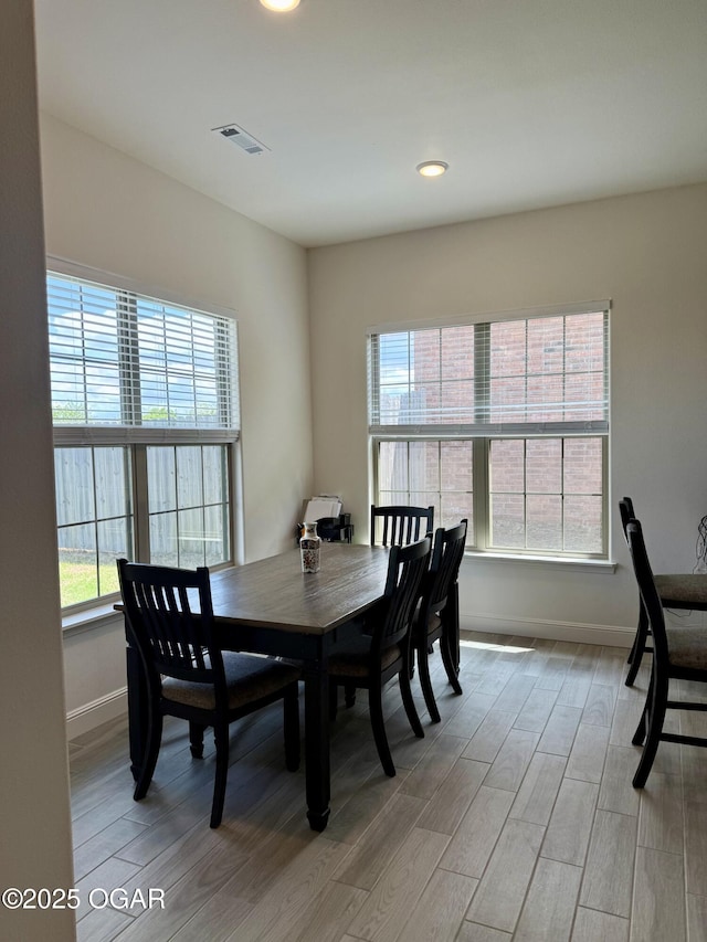 dining area with recessed lighting, baseboards, visible vents, and light wood-type flooring