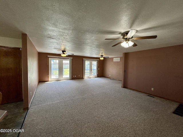 spare room with visible vents, a textured ceiling, and a ceiling fan