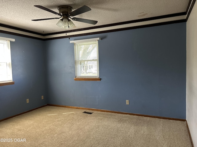 spare room with a textured ceiling, baseboards, a ceiling fan, and carpet
