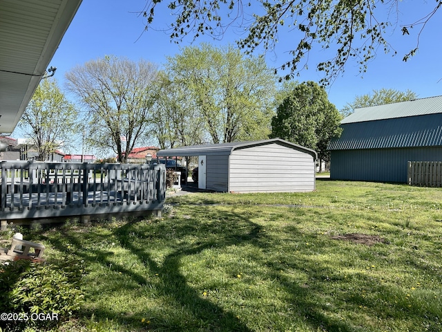 view of yard featuring an outbuilding and a wooden deck