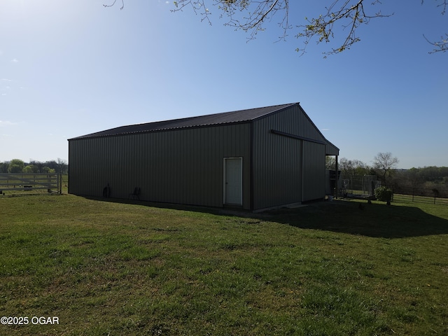 view of pole building featuring a yard and fence