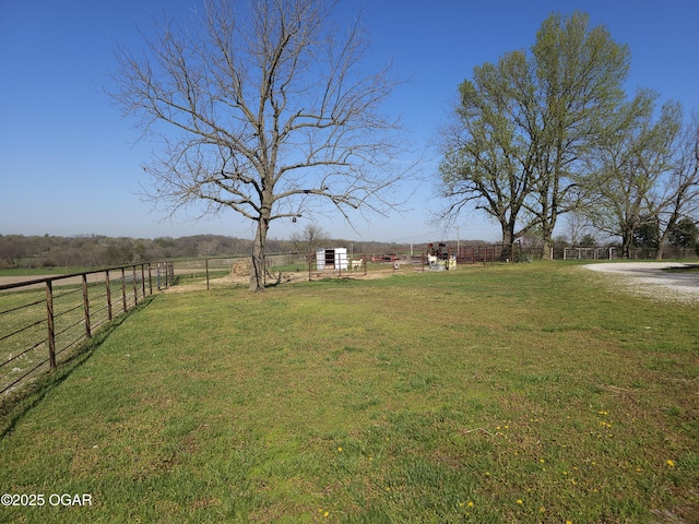 view of yard featuring a rural view and fence