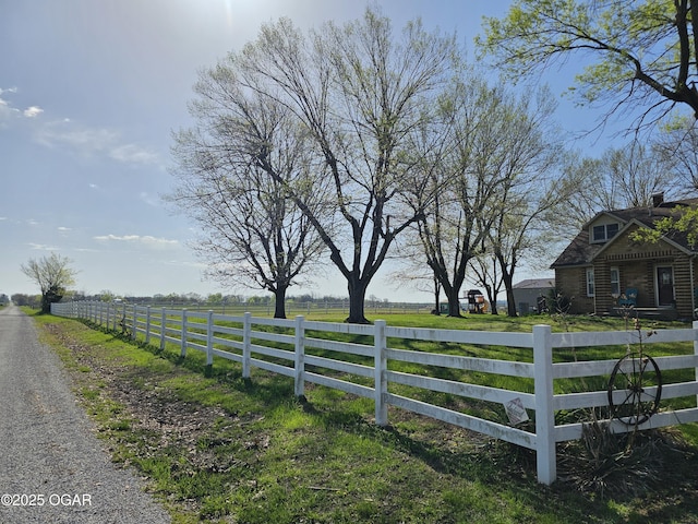 view of gate with fence and a rural view