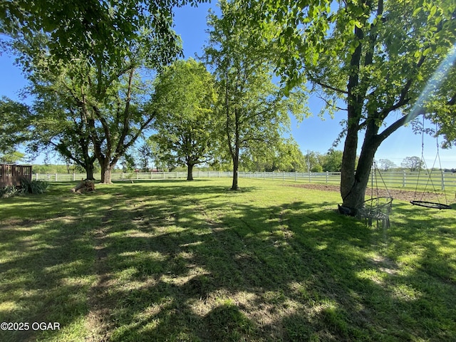 view of yard featuring a rural view and fence