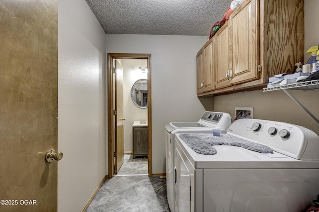 2706 E 26th St, Joplin, MO 64804 - laundry area featuring cabinet space, independent washer and dryer, baseboards, and a textured ceiling