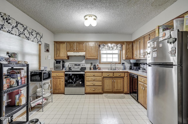 2706 E 26th St, Joplin, MO 64804 - kitchen featuring a textured ceiling, appliances with stainless steel finishes, under cabinet range hood, light countertops, and a sink