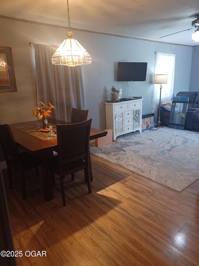 dining space with a notable chandelier and wood finished floors