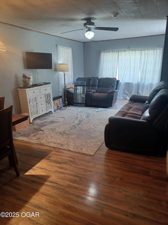 living room featuring wood finished floors and a ceiling fan