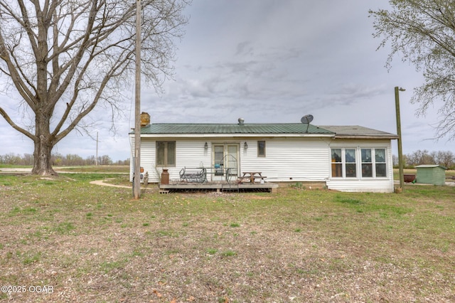 241 SE 40th Rd, Lamar, MO 64759 - rear view of property featuring a yard, a deck, metal roof, and a chimney