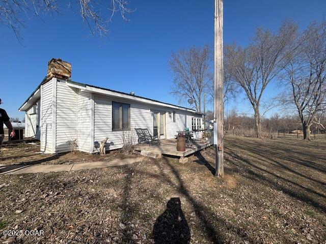 241 SE 40th Rd, Lamar, MO 64759 - view of side of property with a chimney and a wooden deck