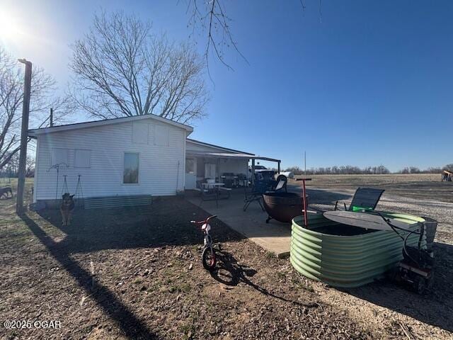 241 SE 40th Rd, Lamar, MO 64759 - view of side of home featuring a patio