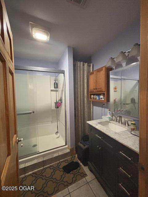 241 SE 40th Rd, Lamar, MO 64759 - full bath featuring a shower stall, tile patterned floors, vanity, and visible vents