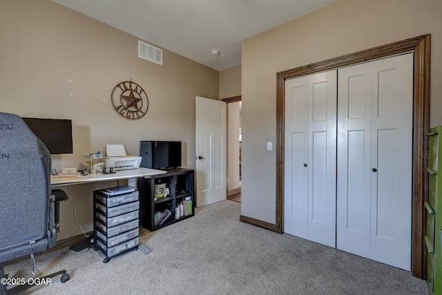 carpeted home office featuring baseboards and visible vents