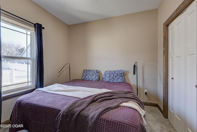 carpeted bedroom featuring baseboards