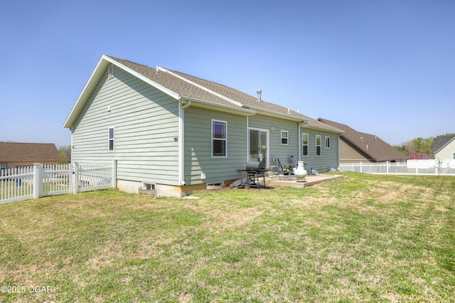 rear view of house featuring a yard, a fenced backyard, and a patio