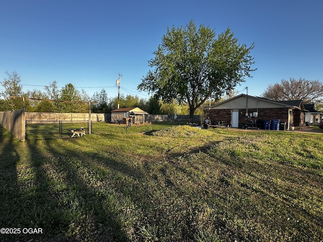 2027 P St SW, Miami, OK 74354 - view of yard with fence and an outbuilding