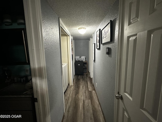 2027 P St SW, Miami, OK 74354 - corridor featuring a textured wall, a textured ceiling, and dark wood finished floors